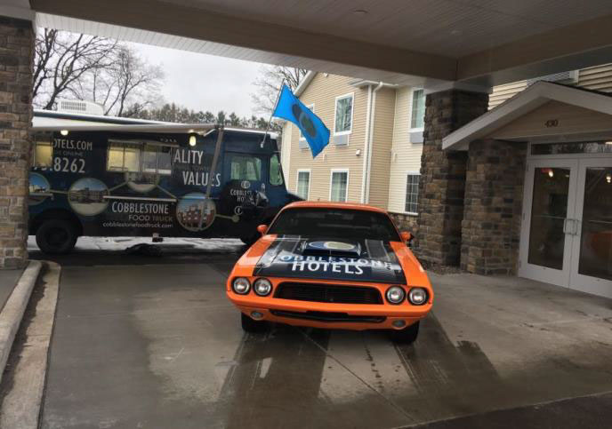 sports car in front of the new cobblestone inn and suites 