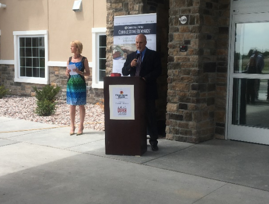 speaker at front entrance to cobblestone property