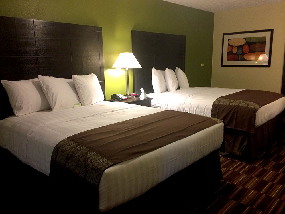 guest room with two queen beds at a boarders inn and suites