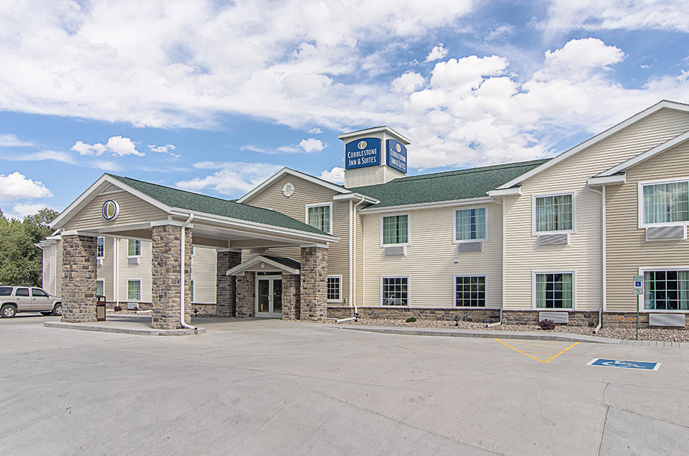 exterior of a cobblestone inn and suites