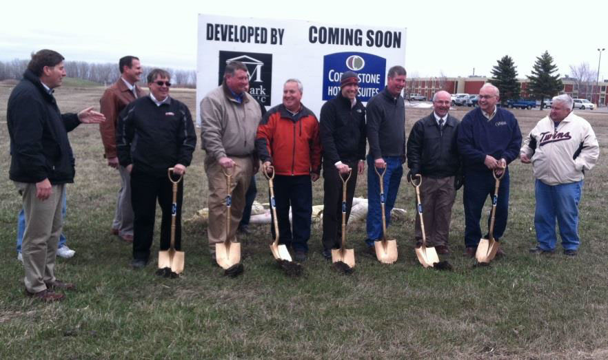 people with shovels breaking ground at the new cobblestone hotel and suites
