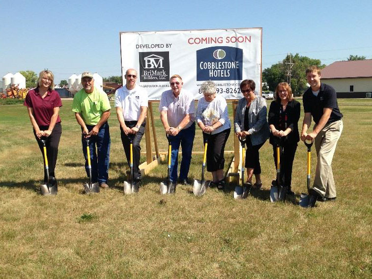 people with shovels breaking ground at the new cobblestone inn and suites