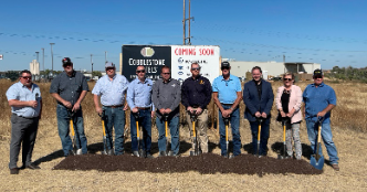 A group of people standing in front of a sign

Description automatically generated with medium confidence